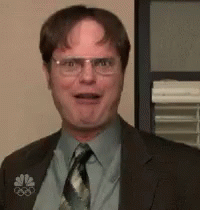 A Man In A Suit And Tie Is Making A Face . GIF