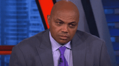 A Man In A Suit And Tie Is Making A Face GIF