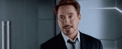 A Man In A Suit And Tie Is Making A Funny Face . GIF