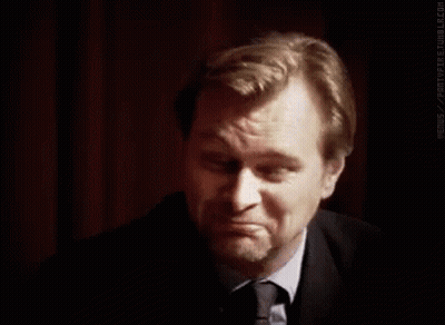 A Man In A Suit And Tie Is Making A Funny Face . GIF
