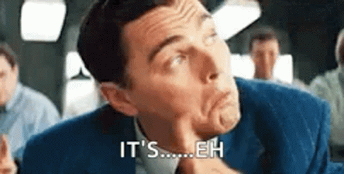 A Man In A Suit And Tie Is Making A Funny Face And Saying `` It 'S Eh '' . GIF