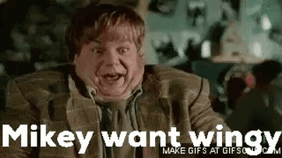 A Man In A Suit And Tie Is Making A Funny Face And Saying `` Mikey Want Wings '' . GIF