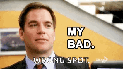 A Man In A Suit And Tie Is Making A Funny Face And Saying `` My Bad , Wrong Spot . '' GIF