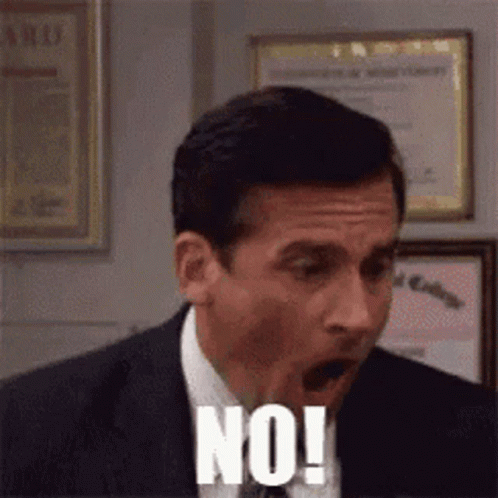 A Man In A Suit And Tie Is Making A Funny Face And Saying No ! GIF
