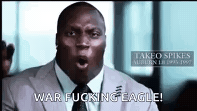 A Man In A Suit And Tie Is Making A Funny Face And Saying War Fucking Eagle . GIF