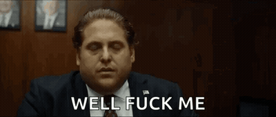 A Man In A Suit And Tie Is Making A Funny Face And Saying Well Fuck Me . GIF