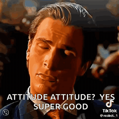 A Man In A Suit And Tie Is Making A Funny Face . GIF