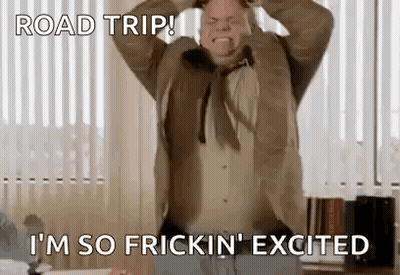 A Man In A Suit And Tie Is Making A Funny Face While Holding His Head . GIF