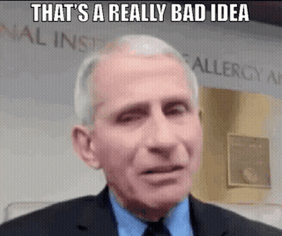 A Man In A Suit And Tie Is Making A Funny Face While Talking . GIF