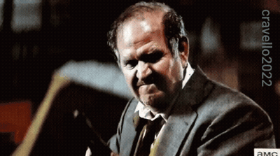 A Man In A Suit And Tie Is Making A Funny Face With A Watermark That Says Orvello2022 GIF