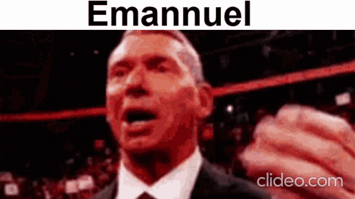 A Man In A Suit And Tie Is Making A Funny Face With The Name Emanuel On The Bottom . GIF