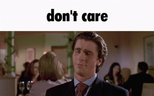 A Man In A Suit And Tie Is Making A Funny Face With The Words " Don 'T Care " Above Him GIF