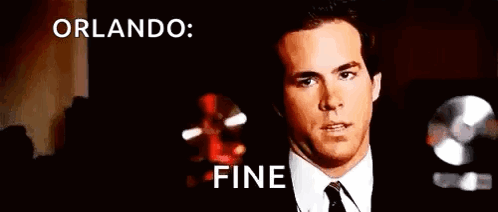 A Man In A Suit And Tie Is Making A Funny Face With The Words Orlando Fine Behind Him . GIF