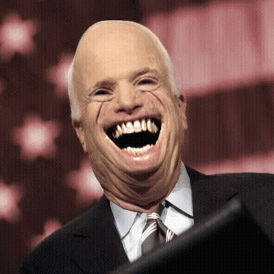 A Man In A Suit And Tie Is Making A Funny Face GIF