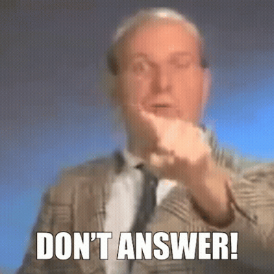 A Man In A Suit And Tie Is Making A Gesture With His Hand And The Words `` Do N't Answer '' . GIF