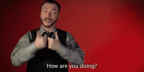A Man In A Suit And Tie Is Making A Gesture With His Hands And Asking How Are You Doing . GIF