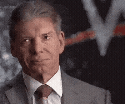 A Man In A Suit And Tie Is Making A Serious Face . GIF