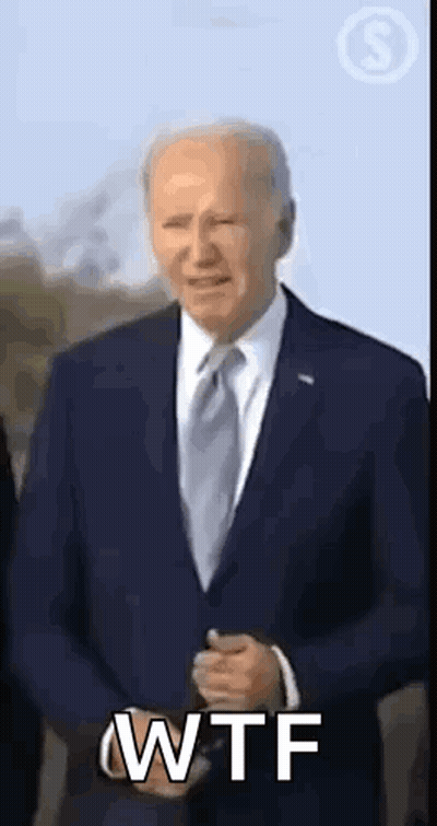 A Man In A Suit And Tie Is Making A Wtf Gesture . GIF