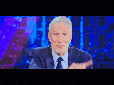 A Man In A Suit And Tie Is On A Television Show GIF