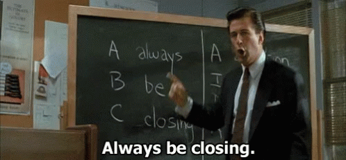A Man In A Suit And Tie Is Pointing At A Blackboard And Saying `` Always Be Closing . '' GIF