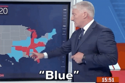 A Man In A Suit And Tie Is Pointing At A Map Of The United States And Says " Blue " GIF