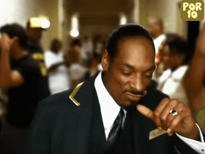 A Man In A Suit And Tie Is Pointing At Something GIF