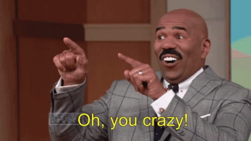 A Man In A Suit And Tie Is Pointing At Something And Says Oh You Crazy GIF