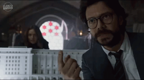 A Man In A Suit And Tie Is Pointing At Something In Front Of A Sign That Says Planeta 000000 GIF