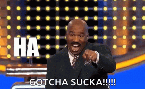 A Man In A Suit And Tie Is Pointing At The Camera And Saying `` Ha Gotcha Sucka '' . GIF