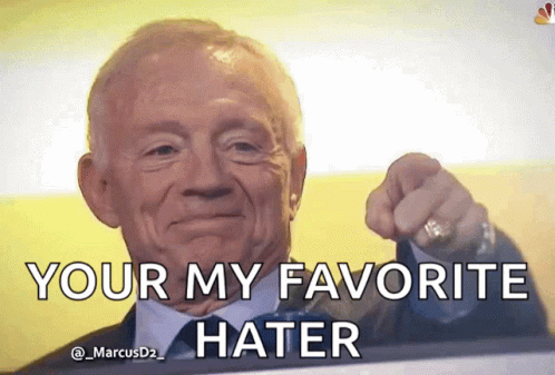 A Man In A Suit And Tie Is Pointing At The Camera With The Caption Your My Favorite Hater GIF