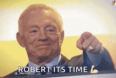 A Man In A Suit And Tie Is Pointing At The Camera With The Words " Robert Its Time " Below Him GIF