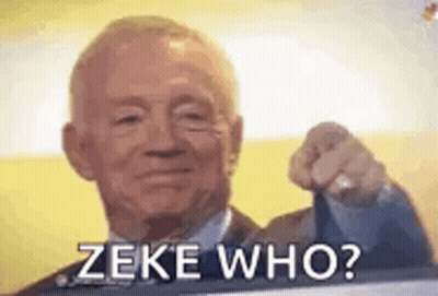 A Man In A Suit And Tie Is Pointing At The Camera With The Words `` Zeke Who ? '' . GIF