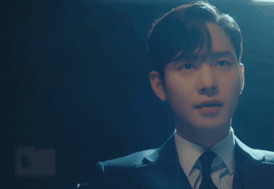 A Man In A Suit And Tie Is Pointing His Finger At Something GIF