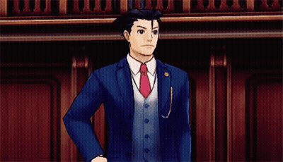 A Man In A Suit And Tie Is Pointing His Finger At The Camera . GIF