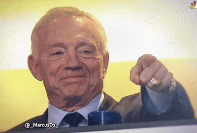 A Man In A Suit And Tie Is Pointing His Finger At The Camera GIF