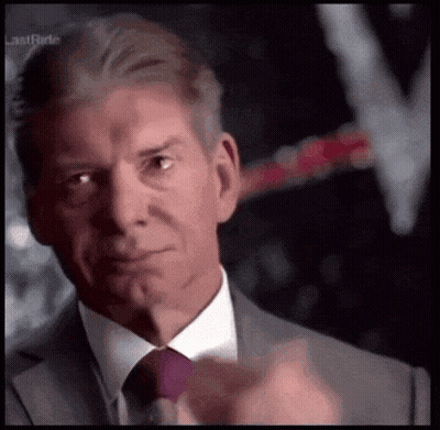 A Man In A Suit And Tie Is Pointing His Finger GIF