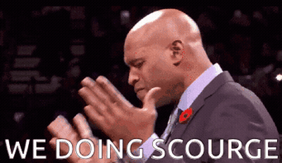 A Man In A Suit And Tie Is Praying With The Words We Doing Scourge Written Below Him GIF