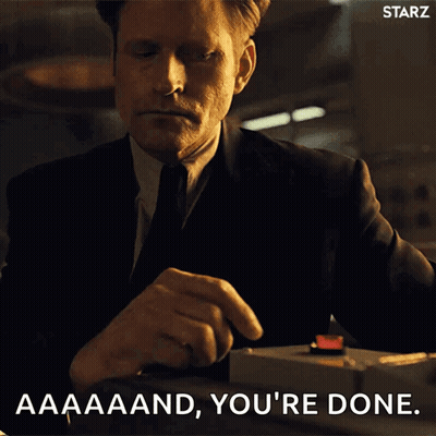 A Man In A Suit And Tie Is Pressing A Red Button And Says " Aaaand You 'Re Done " GIF