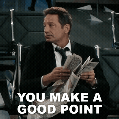 A Man In A Suit And Tie Is Reading A Newspaper With The Words " You Make A Good Point " Above Him GIF