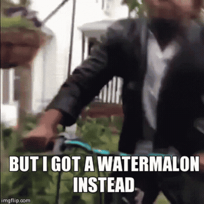 A Man In A Suit And Tie Is Riding A Bike With The Caption But I Got A Watermelon Instead GIF
