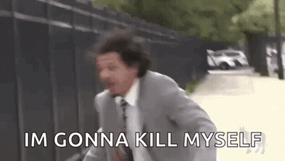 A Man In A Suit And Tie Is Running Down A Street While Saying `` Im Gonna Kill Myself '' . GIF