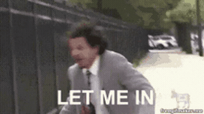 A Man In A Suit And Tie Is Running With The Words Let Me In Behind Him . GIF