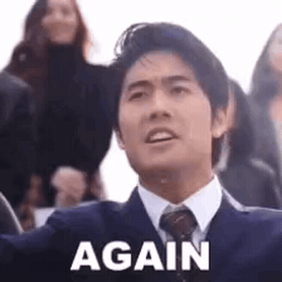 A Man In A Suit And Tie Is Saying `` Again '' . GIF