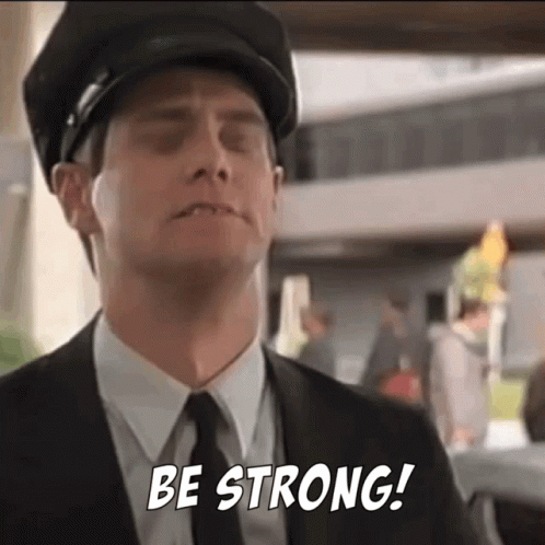 A Man In A Suit And Tie Is Saying Be Strong . GIF
