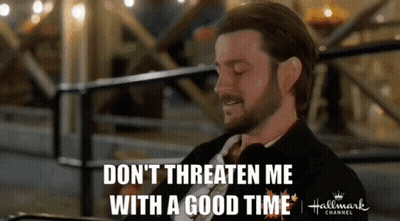 A Man In A Suit And Tie Is Saying " Don 'T Threaten Me With A Good Time " GIF
