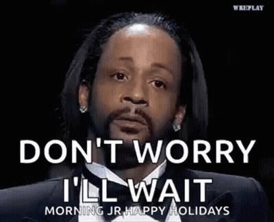 A Man In A Suit And Tie Is Saying `` Don T Worry I 'Ll Wait '' . GIF