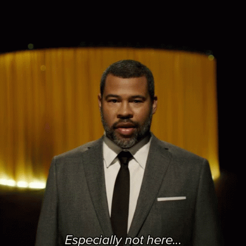 A Man In A Suit And Tie Is Saying Especially Not Here GIF