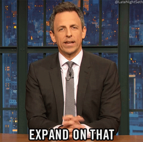 A Man In A Suit And Tie Is Saying " Expand On That " GIF