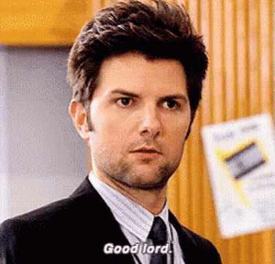 A Man In A Suit And Tie Is Saying " Good Lord " . GIF
