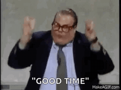 A Man In A Suit And Tie Is Saying `` Good Time '' With His Arms In The Air . GIF